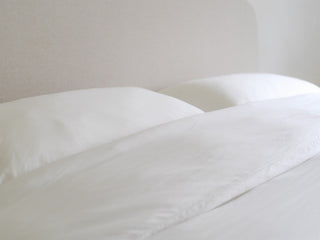 Best pillowcase for acne, smooth Cloud White eucalyptus pillowcase and duvet in soft morning light
