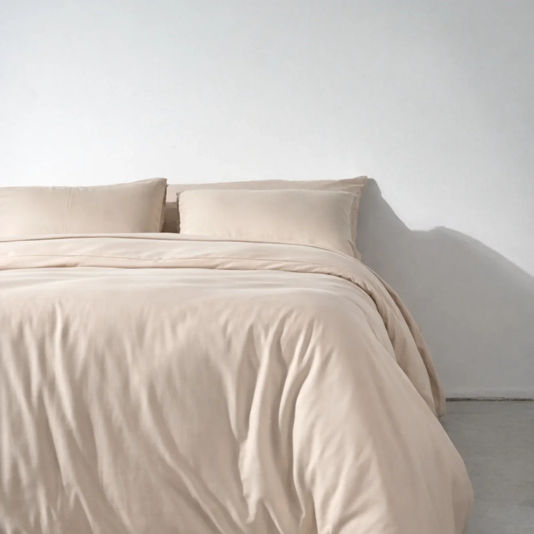 A bed made up with a Soft Cashmere eucalyptus lyocell duvet cover, the washable outer layer of a duvet system