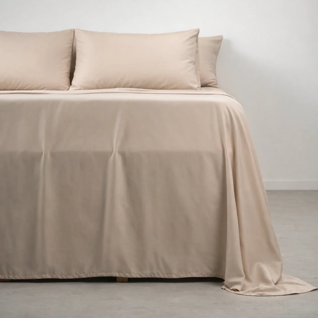 A neatly made bed dressed in Soft Cashmere eucalyptus lyocell sheets, sold on measured fiber specs rather than a thread count
