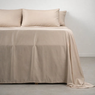 A neatly made bed dressed in Soft Cashmere eucalyptus lyocell sheets, sold on measured fiber specs rather than a thread count