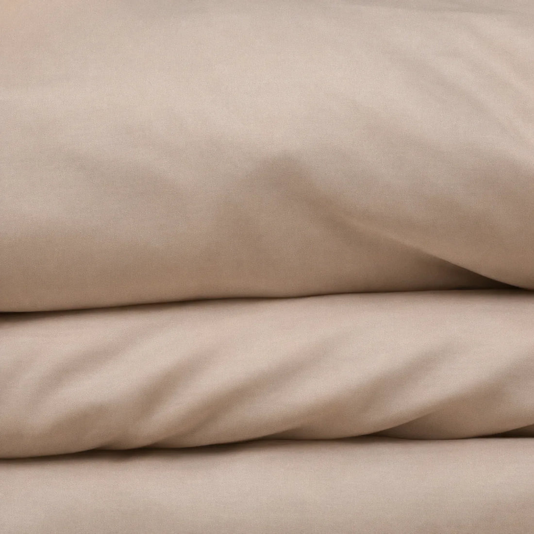 Soft Cashmere CloudThera eucalyptus lyocell sheets folded, showing the smooth low-friction surface a side sleeper's chest presses into