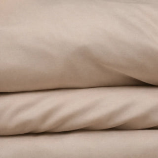 Soft Cashmere CloudThera eucalyptus lyocell sheets folded, showing the smooth low-friction surface a side sleeper's chest presses into