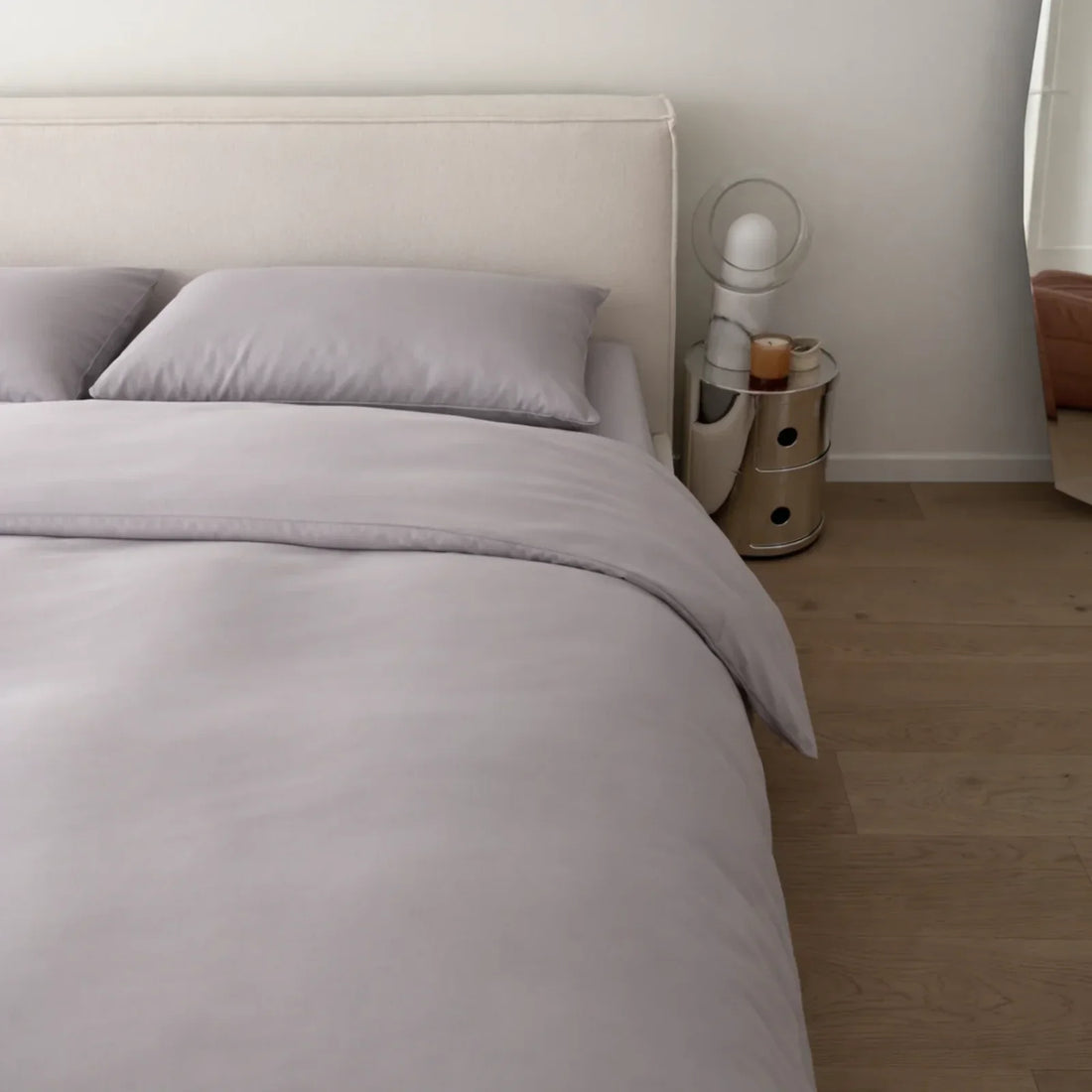 Bed dressed in Gentle Slate eucalyptus lyocell fitted sheet, pillowcases and duvet cover, the surface back and chest sweat pimples form against overnight