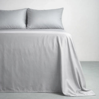 Gentle Slate eucalyptus lyocell sateen sheets on a made bed, the smooth low-luster surface at the center of the percale vs sateen question