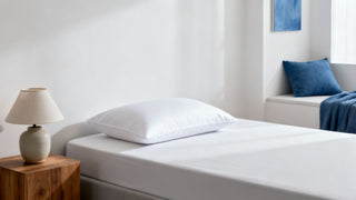 A pristine Dreamey CloudThera pillowcase in a clean, minimalist bedroom, symbolizing a hygienic sleep environment for healthy skin.