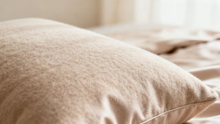 A luxurious, soft-looking Dreamey CloudThera pillowcase in a neutral soft cashmere color, with a close-up showing the smooth, gentle texture of the fabric.