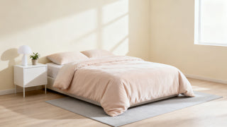 A serene, minimalist bedroom scene featuring soft-toned Dreamey CloudThera bedding, emphasizing comfort and clean, modern design for better sleep.