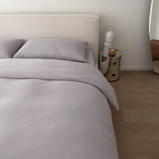 A bed made up in Gentle Slate eucalyptus lyocell pillowcases, the surface the lower face presses into all night