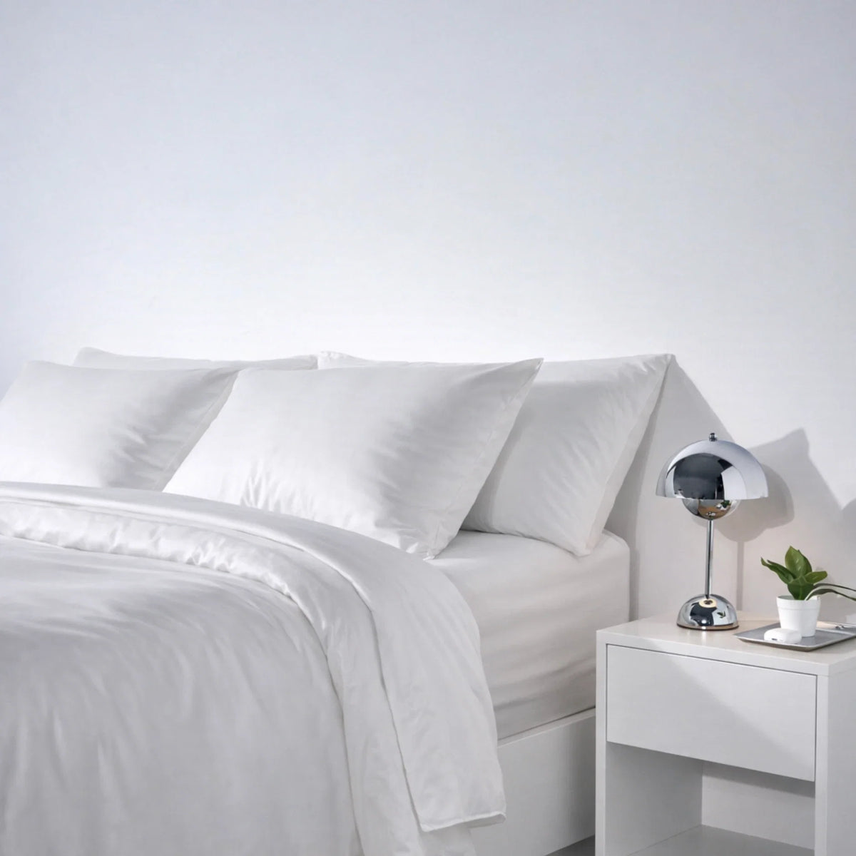 Side angle of a bed dressed in the Buttercream eucalyptus Complete Sleep set