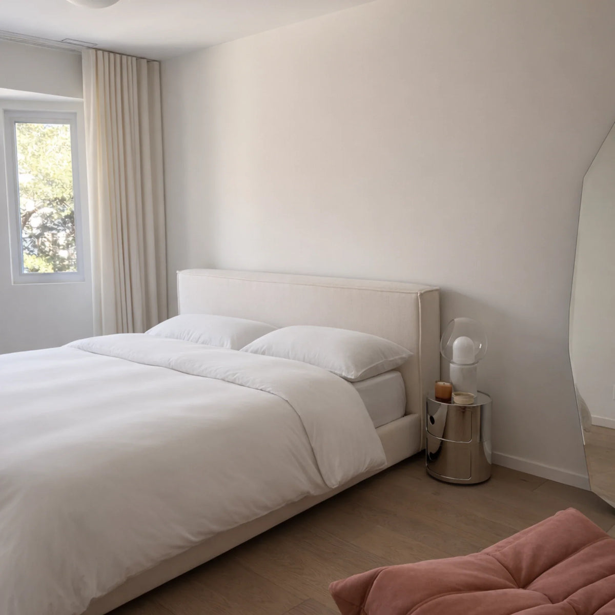 Side view of a bed dressed in the Buttercream eucalyptus Complete Sleep set near a window